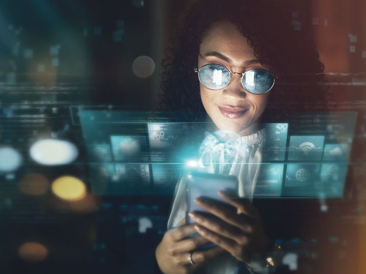 Woman with sunglasses using smartphone surrounded by glowing digital screens and data visualizations